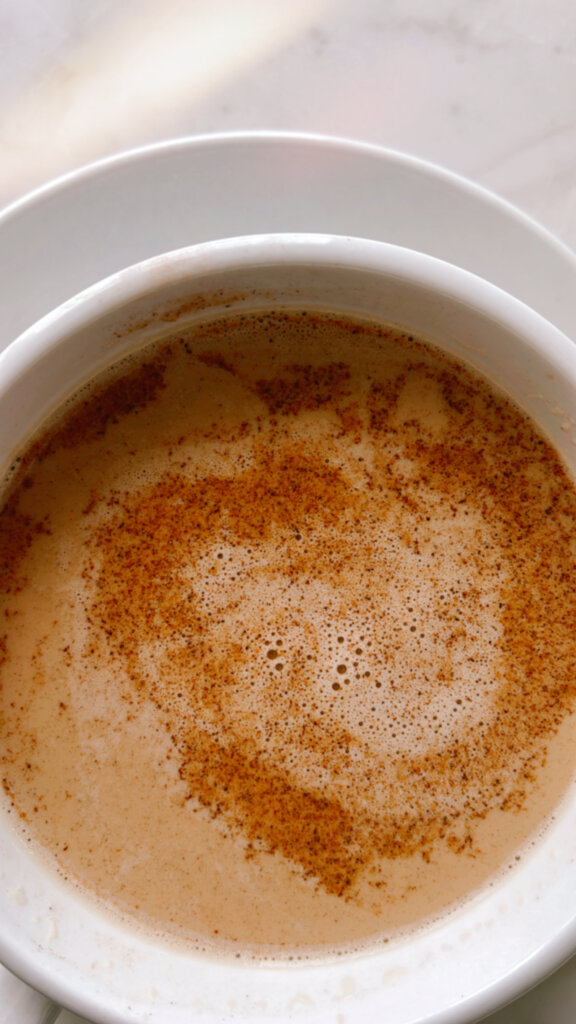 Café au Lait drink close up with cinnamon in a white mug