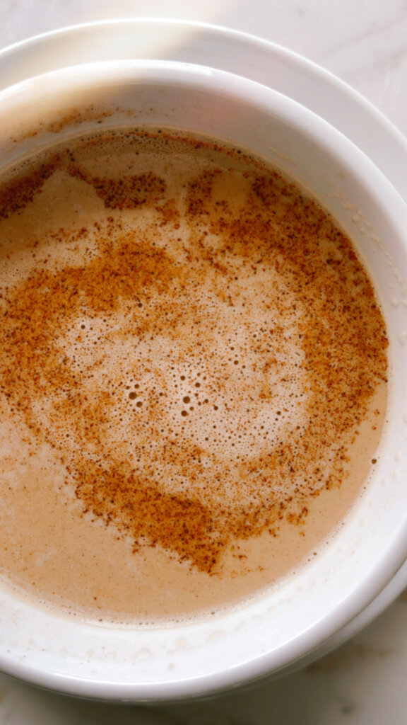 Café au Lait drink close up with cinnamon in a white mug