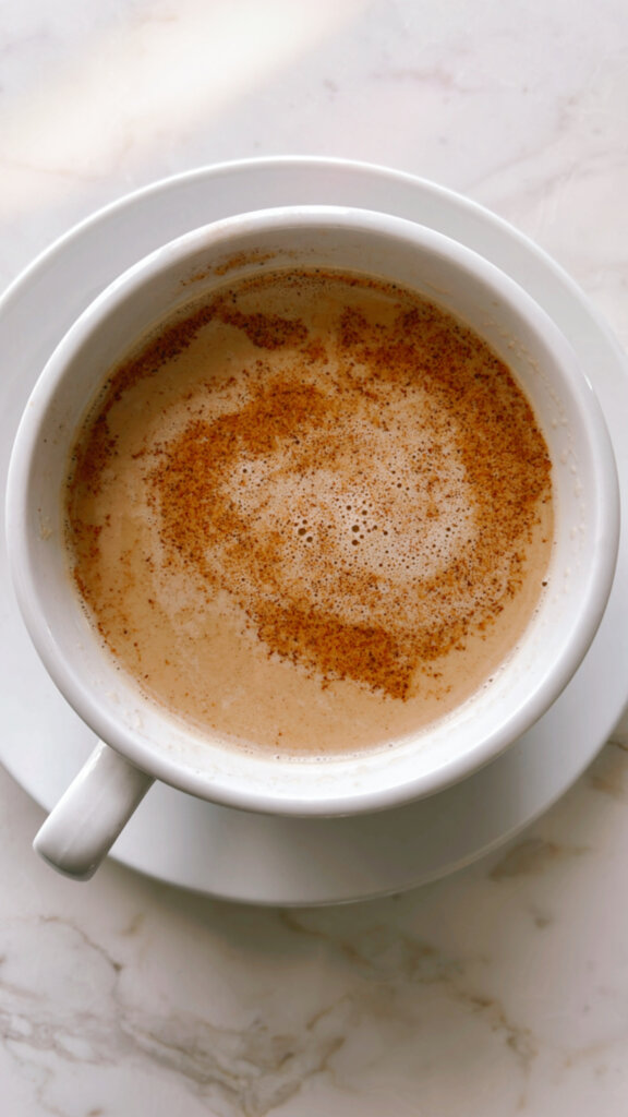 Café au Lait drink close up with cinnamon in a white latte mug