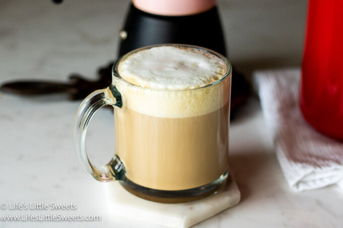Caffè Latte recipe in clear mug on a marble countertop