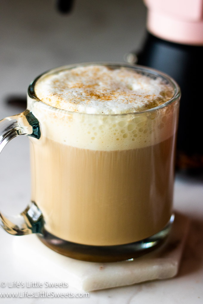 Caffè Latte recipe in clear mug on a marble countertop