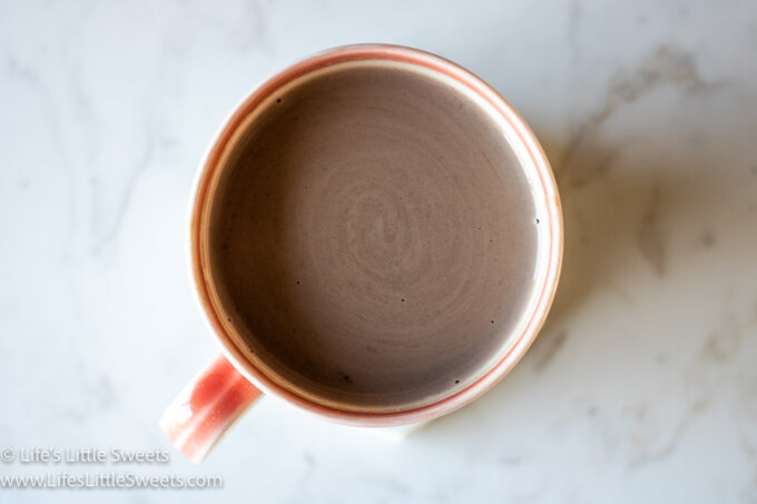 an overhead view of hot chocolate on a marble counter