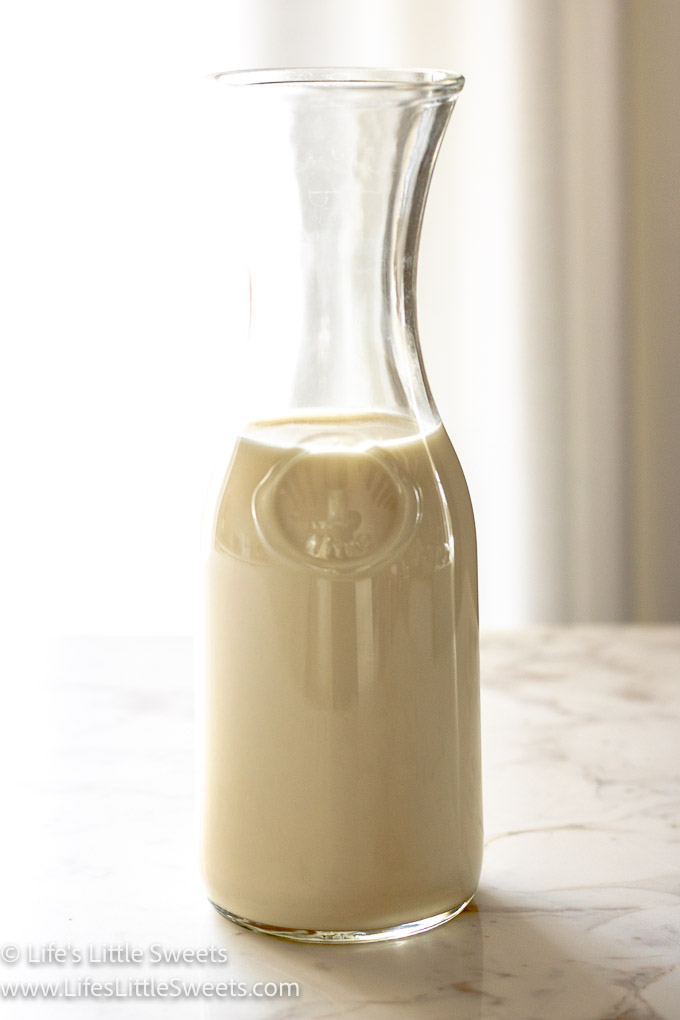 oat milk in a clear glass milk bottle