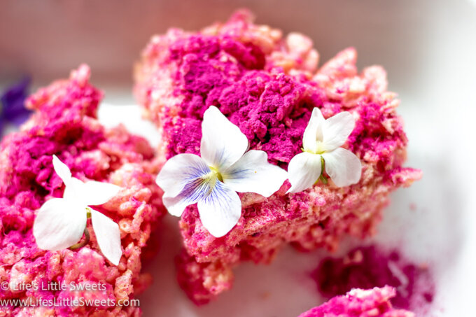 pink rice Krispies treats with flowers in a white platter