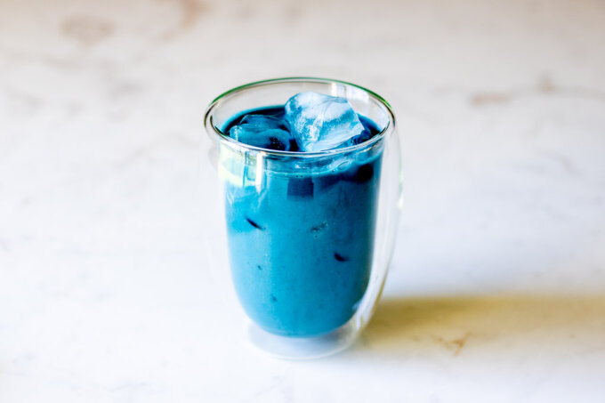Butterfly Pea Flower Milk Tea overhead with ice on a marble countertop