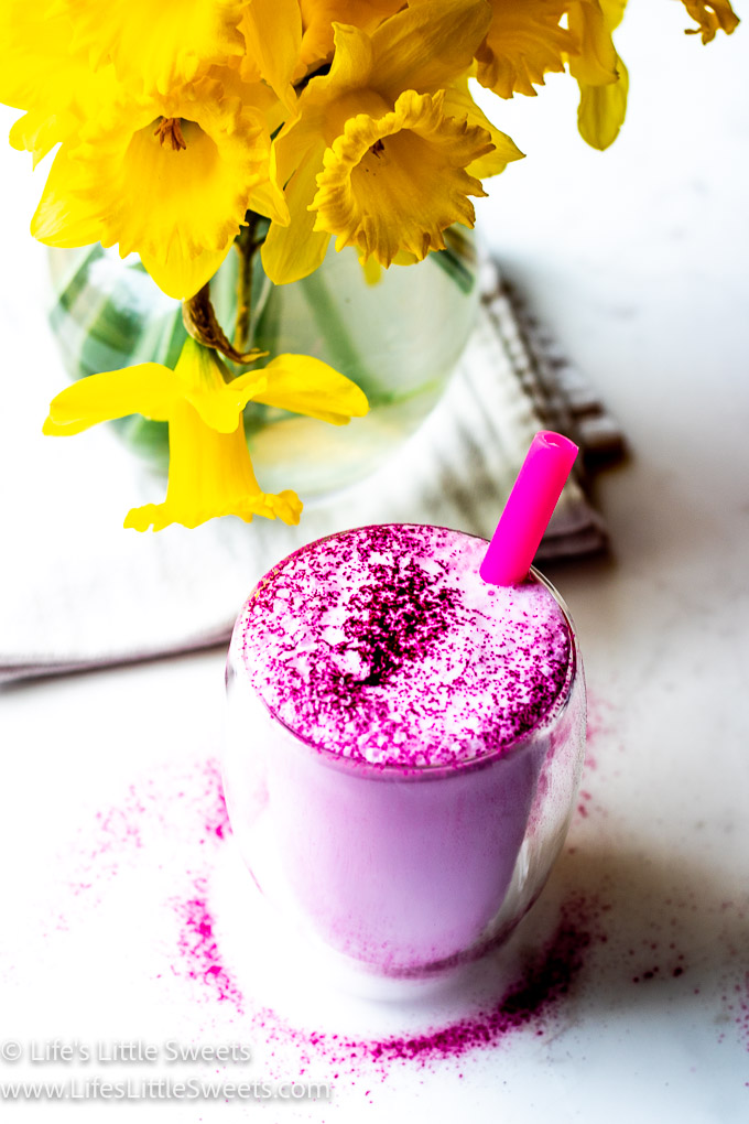 Dragon Fruit Steamed Milk with a pink straw