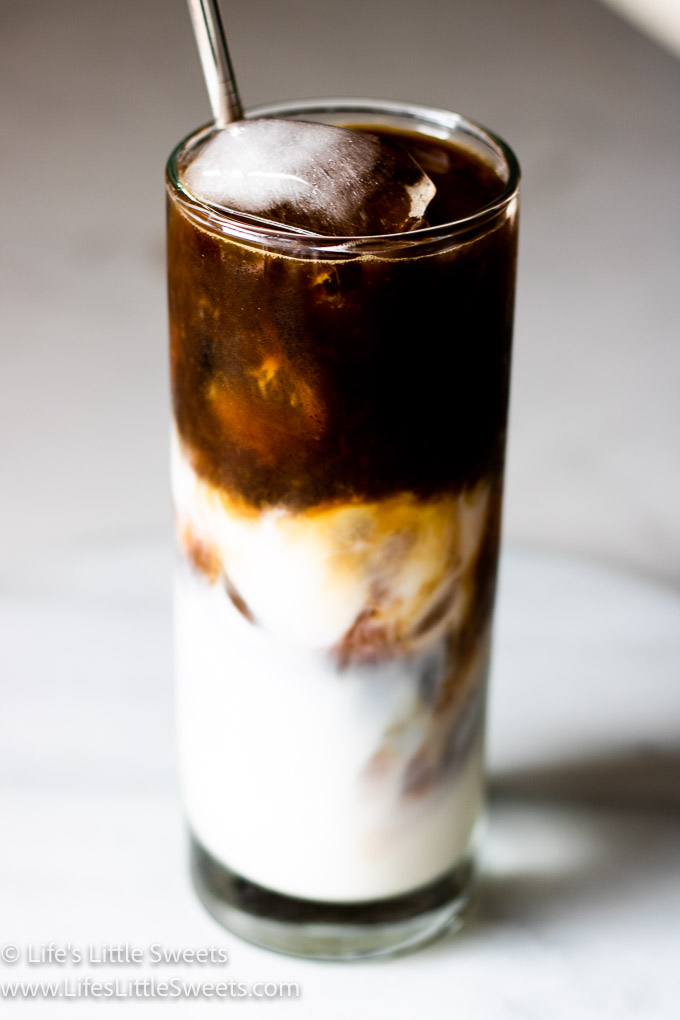 Iced Coffee with Almond Milk on a marble counter close up