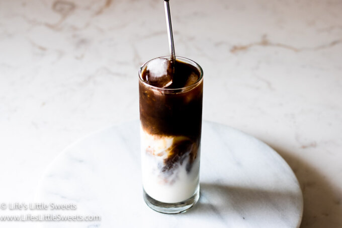 Iced Coffee with Almond Milk on a marble counter on a marble lazy susan stand