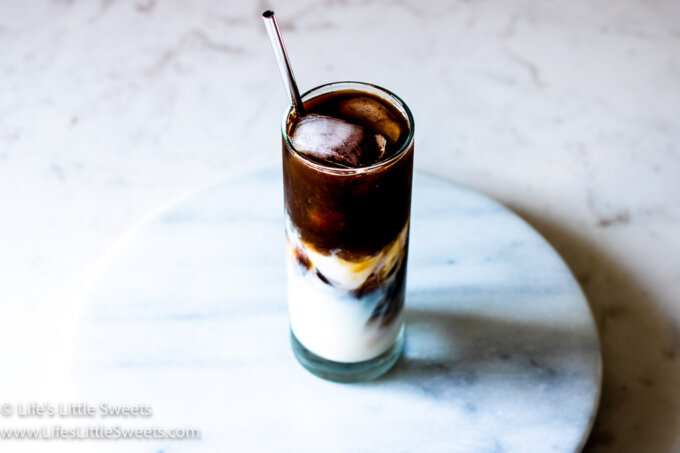 Iced Coffee with Almond Milk on a marble counter on a marble lazy susan