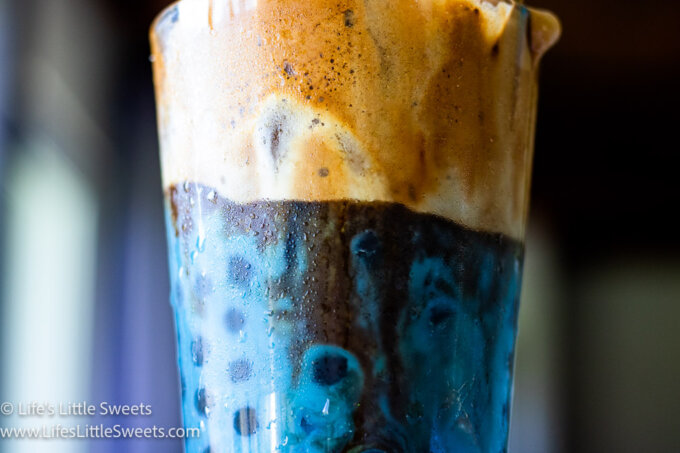 a blue whipped coffee drink with boba