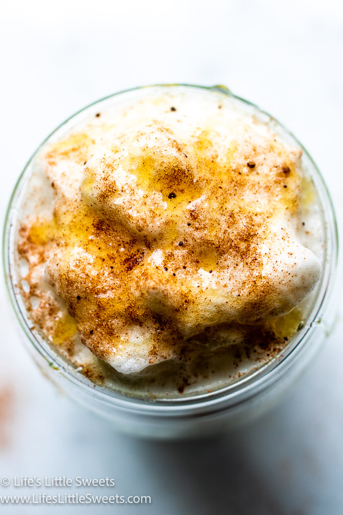 a close up of foam with cinnamon on top and honey