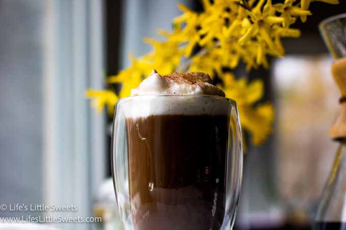 coffee with soy milk foam and yellow flowers