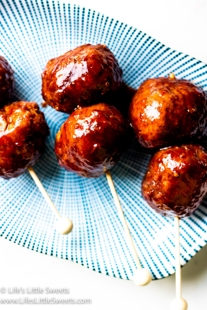 close up of skewered meatballs on a serving dish