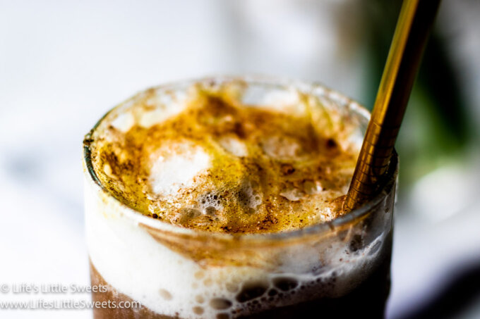 Soy Milk Iced Coffee Recipe with yellow flowers on a marble counter