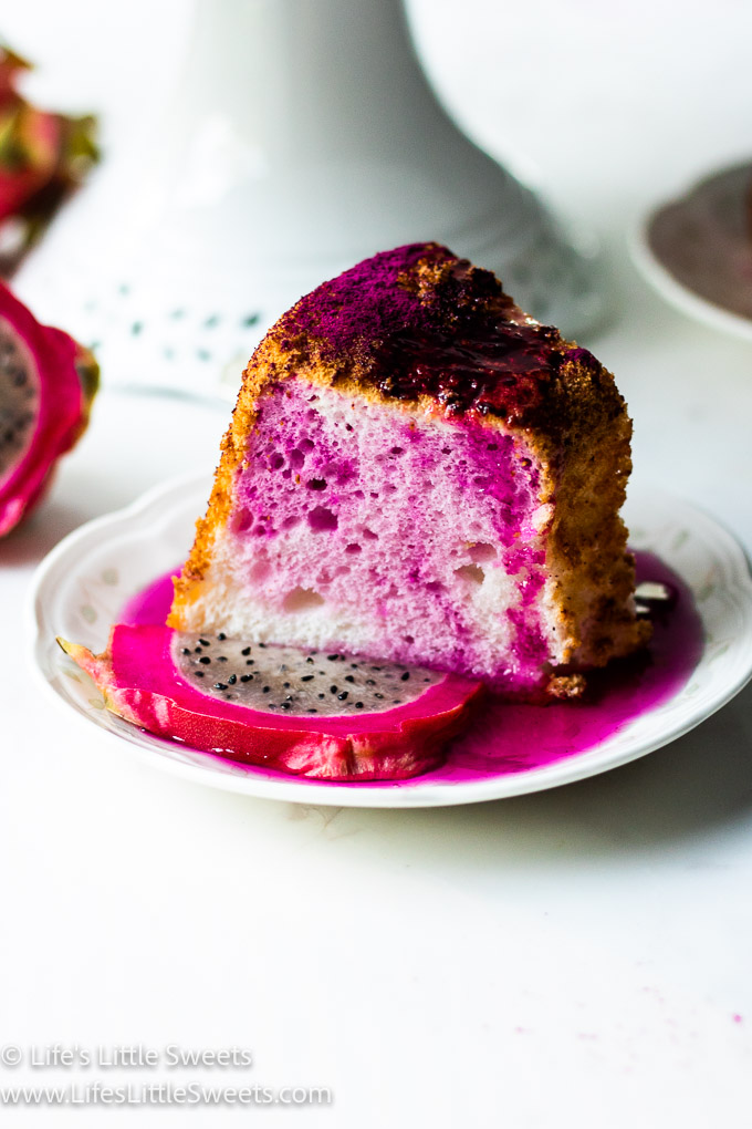 dragon fruit slice with pink and white cake on a plate