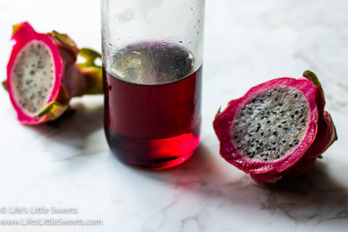 red dragon fruit simple syrup in a glass bottle