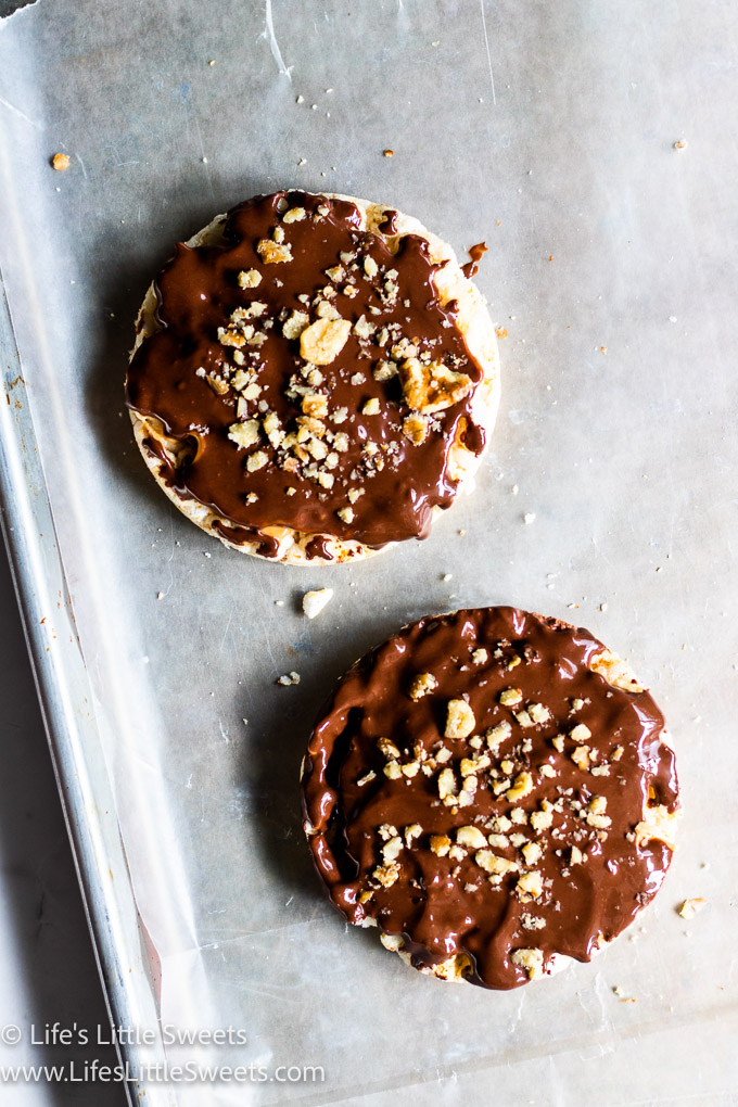chocolate-covered rice cakes with nuts on a baking sheet
