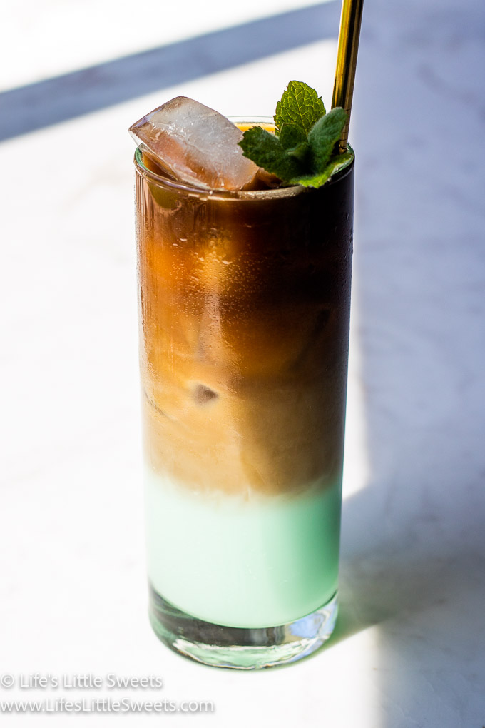 green iced coffee with mint on a white marble counter