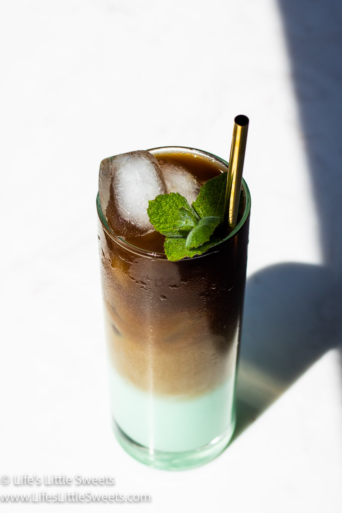 green iced coffee with mint on a white marble counter with ice
