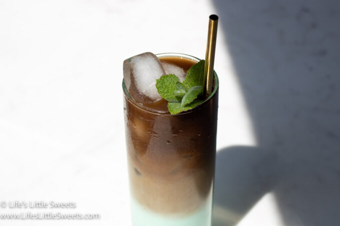 iced coffee with mint sprigs on a marble counter