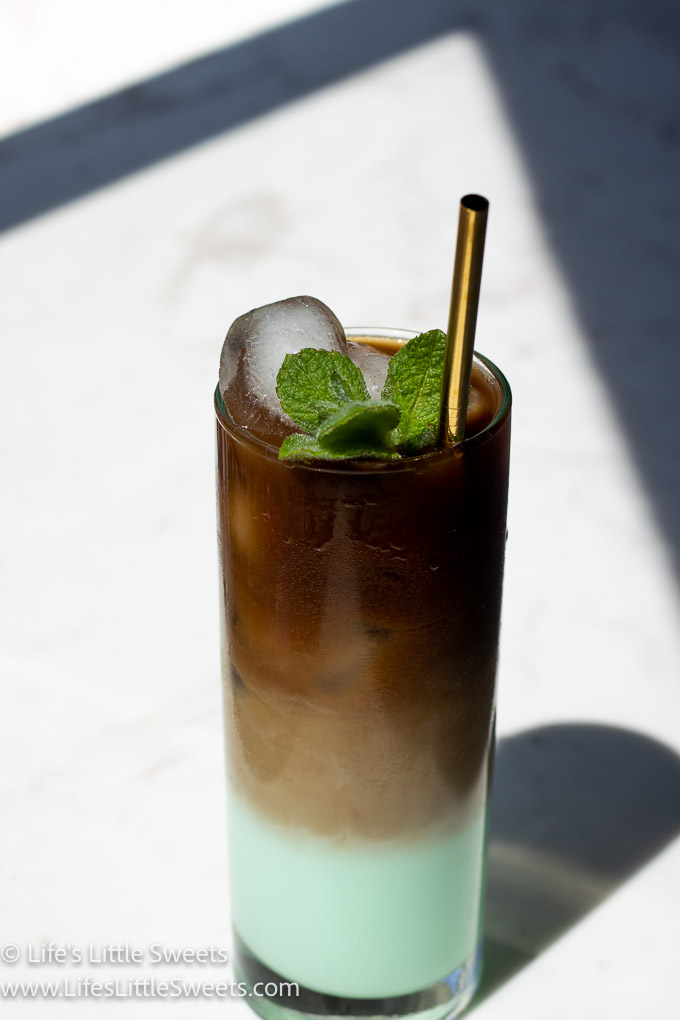 green iced coffee with mint on a white marble counter