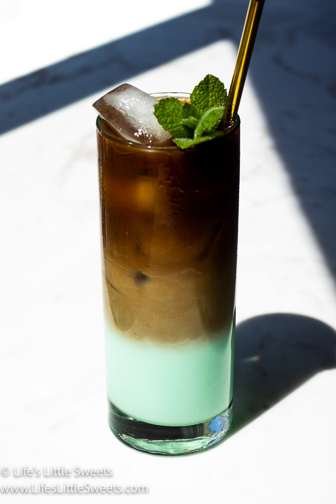 green iced coffee with mint on a marble counter