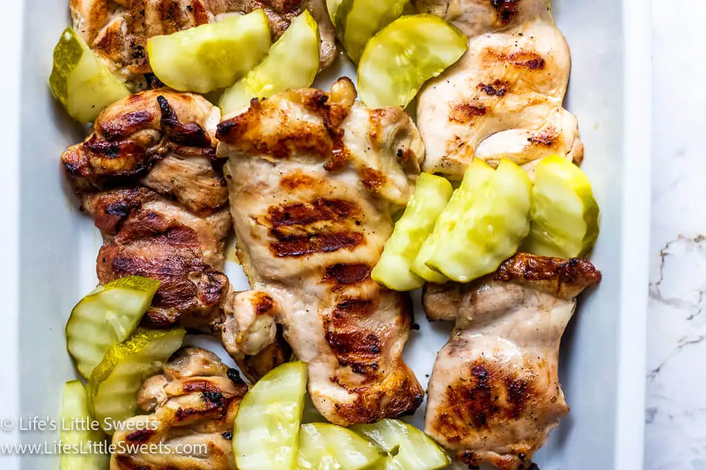 green pickles with grilled chicken in a white dish