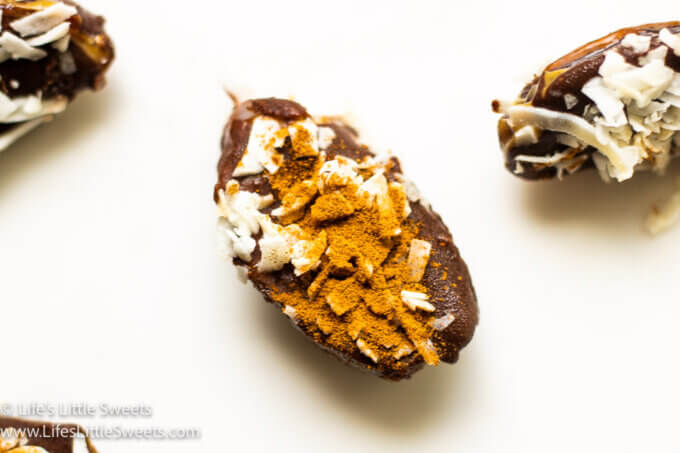 Frozen Stuffed Dates with cinnamon and coconut flakes on a white background