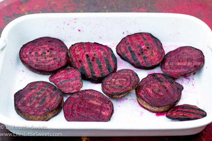 Grilled Beets in a white dish on a red metal table