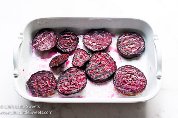 red Grilled Beets in a white serving platter with a white background