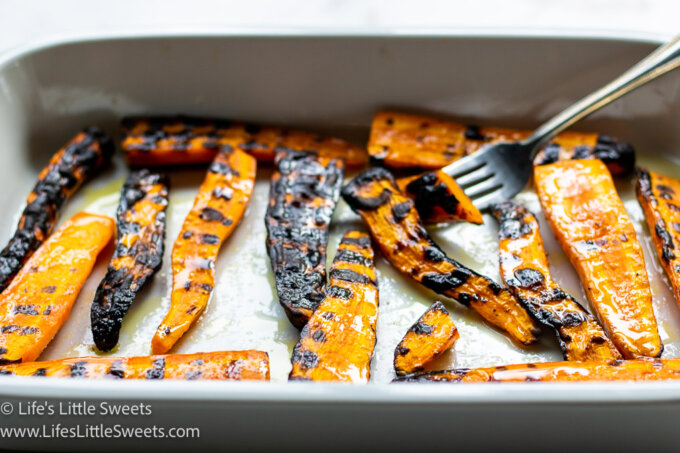 grilled carrots in a white dish