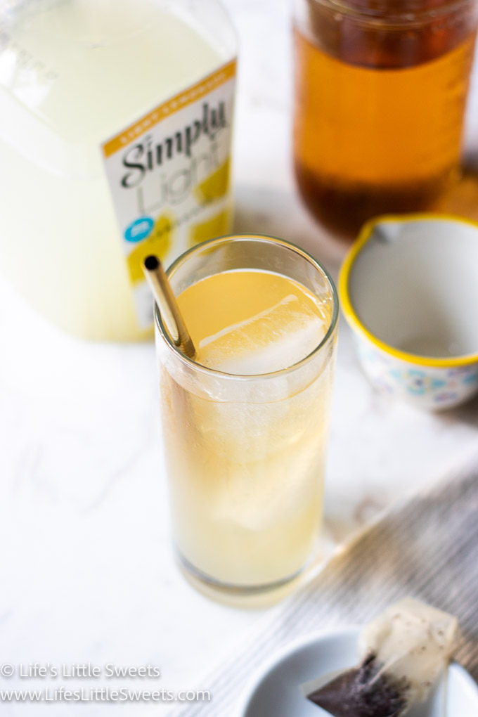 yellow drink on a white table with other ingredients