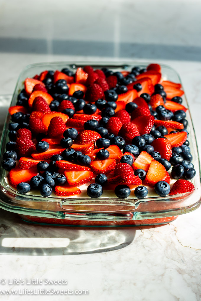 a 9x13-inch pan of cake with berries