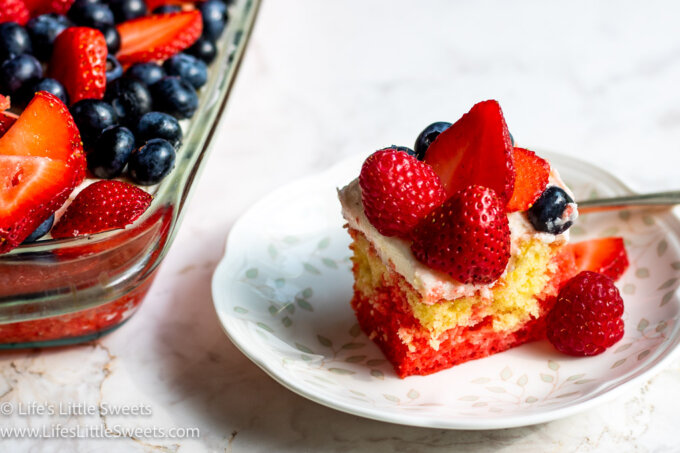 a 9x13-inch pan of cake with berries and a plate with a serving of cake on it