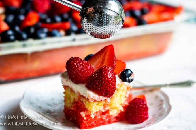 a 9x13-inch pan of cake with berries and a slice of cake on a plate