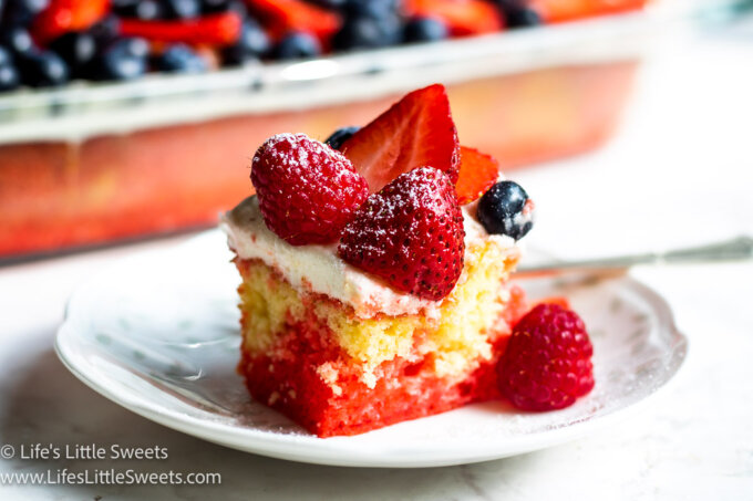 a 9x13-inch pan of cake with berries with a close up of 1 serving of cake