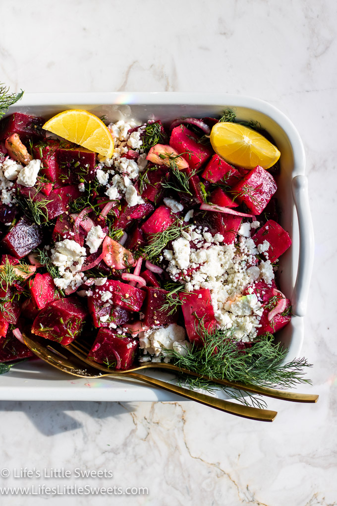beet salad with gold utensils with lemons