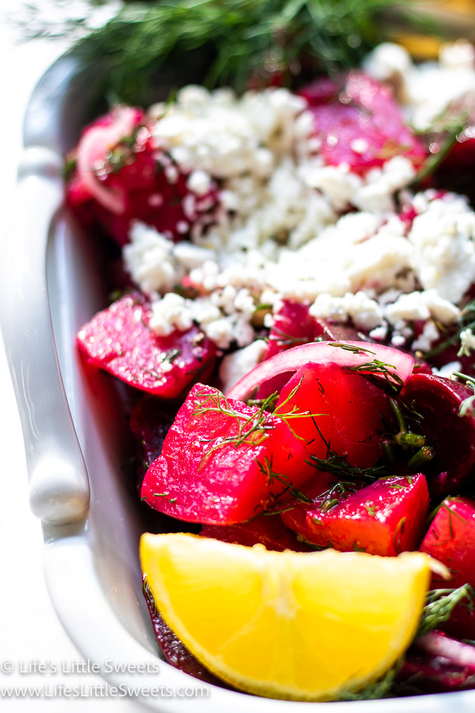 beets, lemon, onions and feta with dill in a white dish