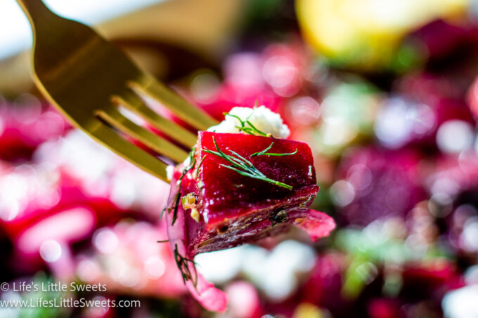 beet with dill and cheese on a gold fork