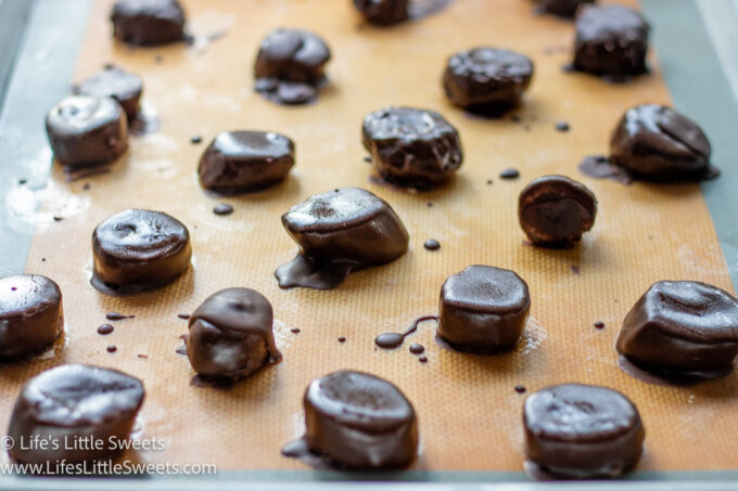 a rimmed baking sheet of chocolate-covered frozen banana slices