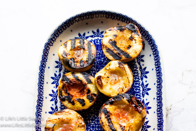 grilled peaces on a blue and white oval plate on a white countertop