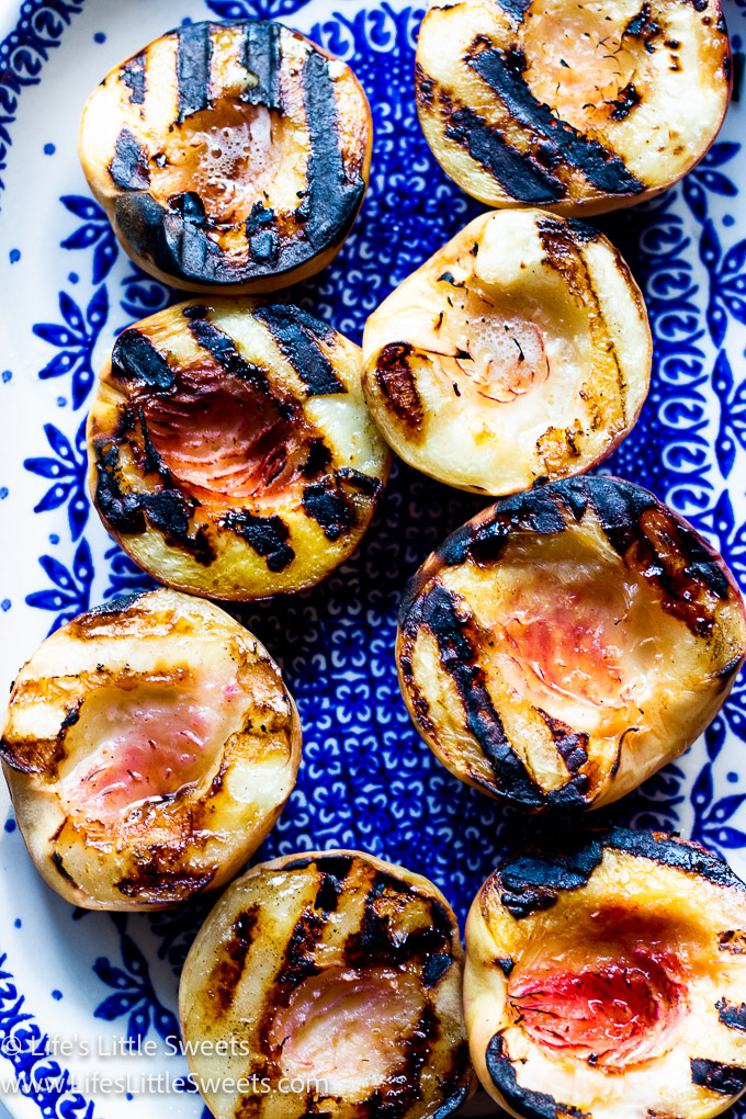 cooked peaches with grill marks on a blue and white plate