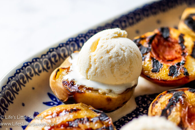 a scoop of ice cream over a grilled peach half