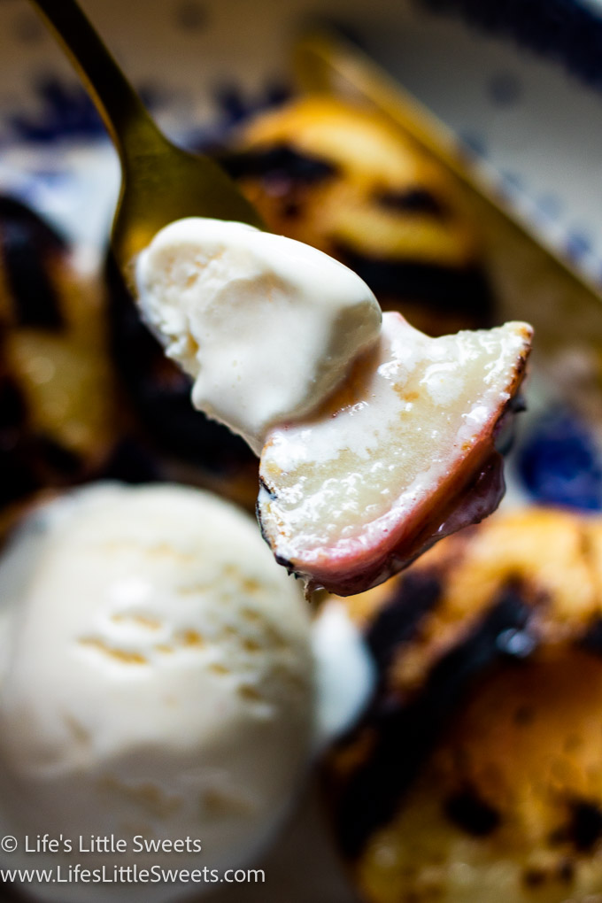 a bite of grilled peach with vanilla ice cream
