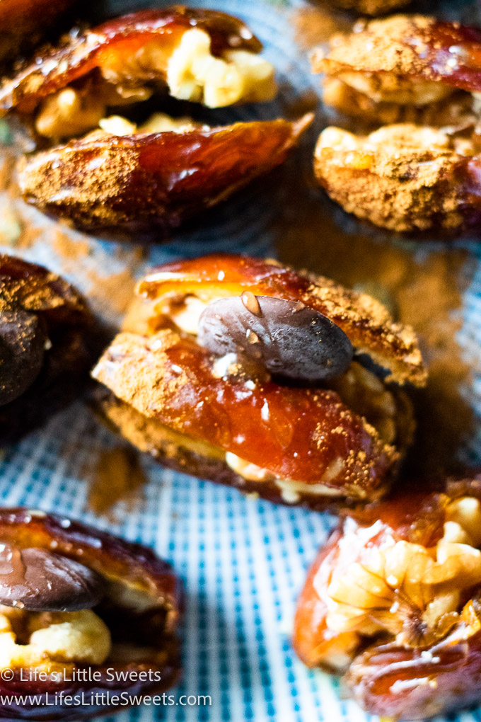close up of a chocolate stuffed date with honey and nuts