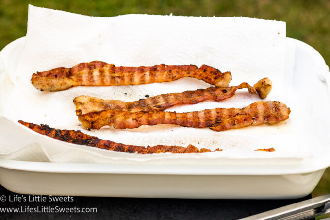 grilled bacon cooling on a white paper towel