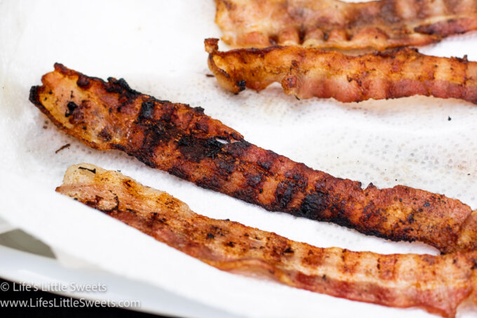 grilled bacon cooling on white paper towels
