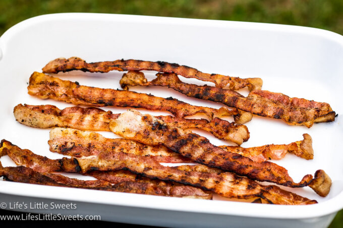 grilled bacon on a white plate outside