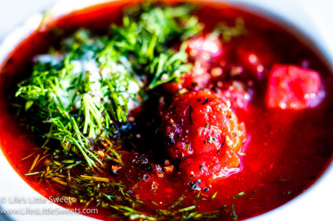 red Borscht soup with dill and sour cream close up