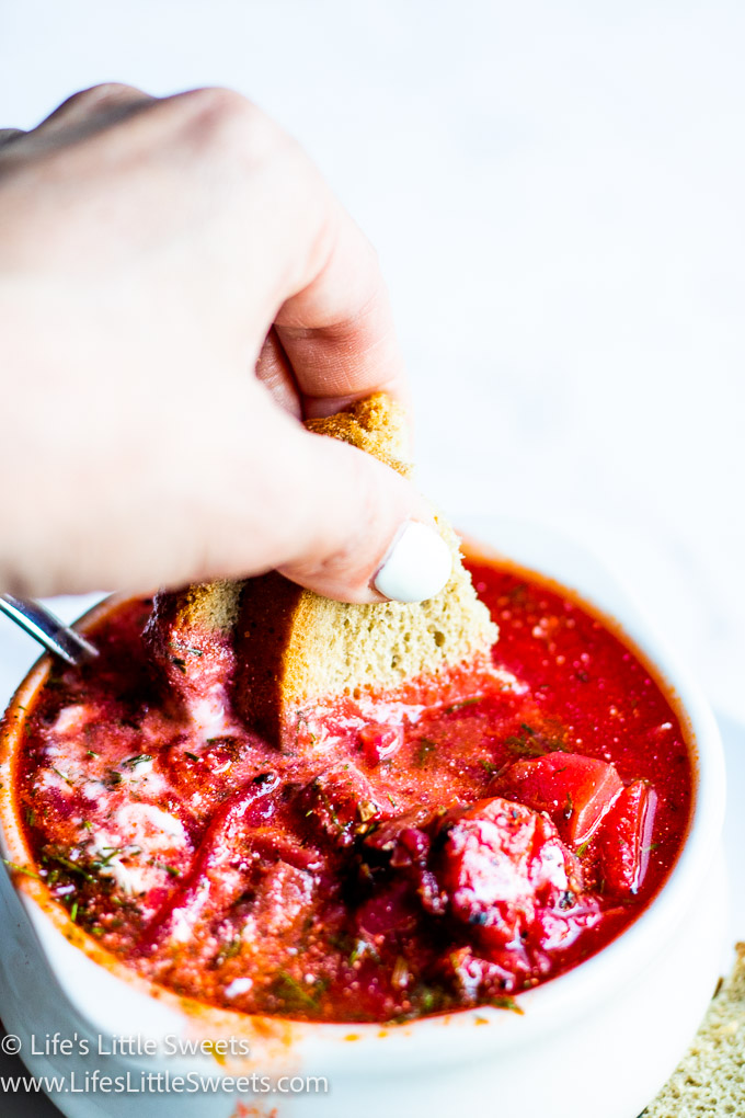 red Borscht soup with dill and sour cream mixed up